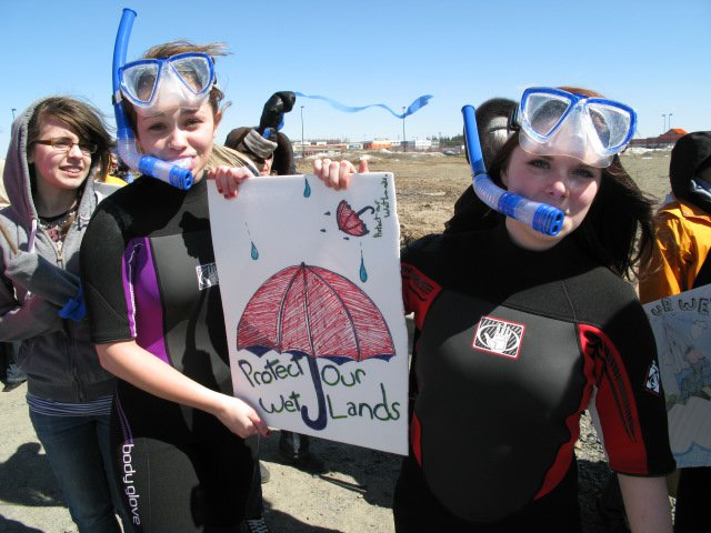 Participants of a rally to save the UNB Woodlot wear scuba gear to make a point about the importance of wetlands to water retention and flood control. Photo: Kevin Matthews. unbwoodlotaction-kevin