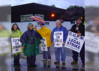 Postal workers back to work but not giving up the fight