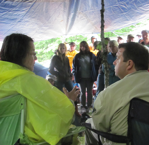 Alma Brooks, a Maliseet elder and Kirk MacDonald, the York North MLA, speak in a meeting at the blockade of seismic vibrators in Stanley, NB. Photo: Tracy Glynn. alma-kirk-sm