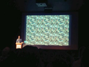 Sean Devlin, filmmaker, creative activist and comedian, opens his talk with the faces of some of the estimated 800 missing and murdered Aboriginal women in Canada. Photo by Robert Leamon. 